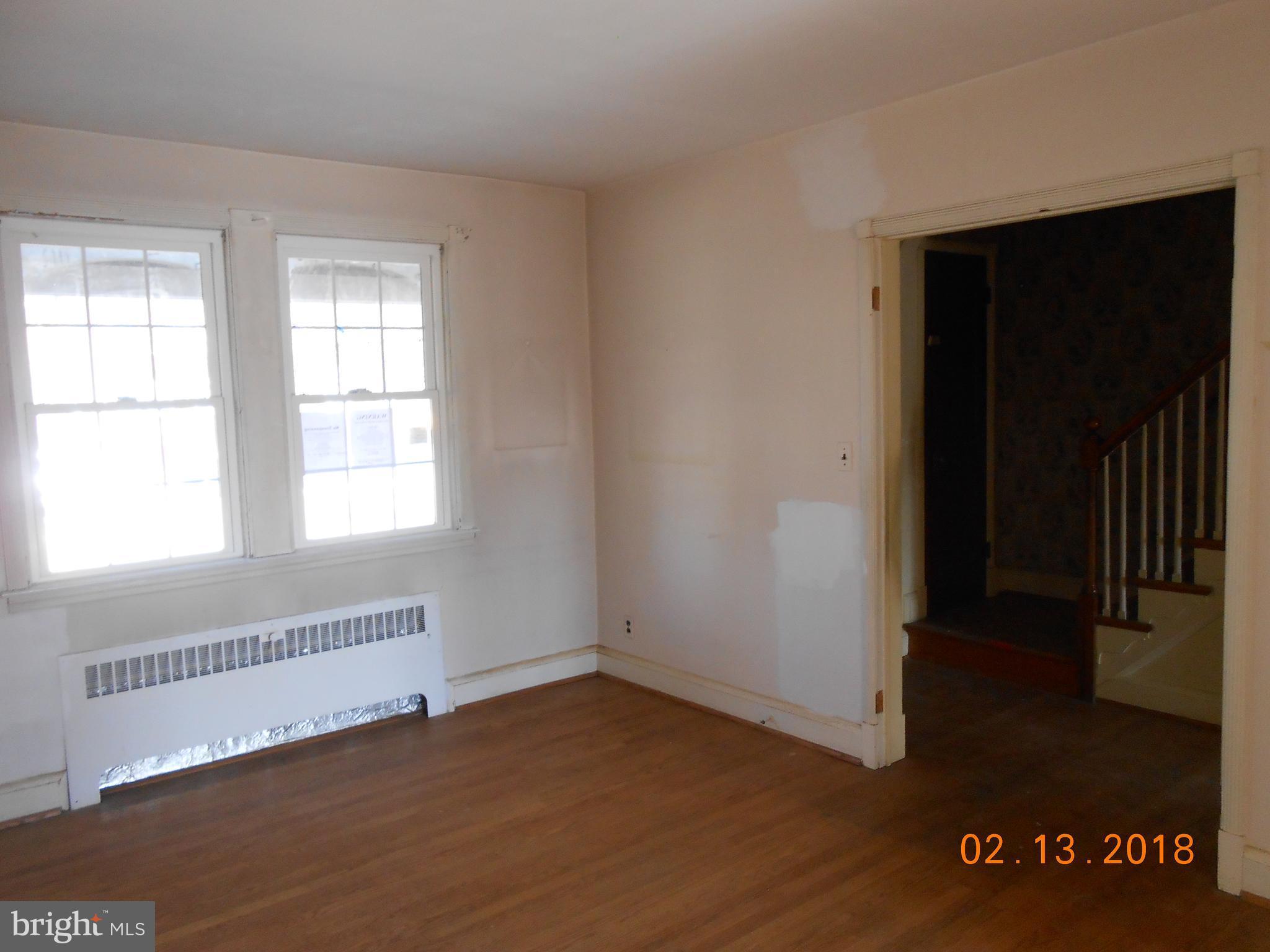 411 Dumbarton Road Baltimore, MD 21212 - Photo 4 of 25 a view of an empty room with wooden floor and a window