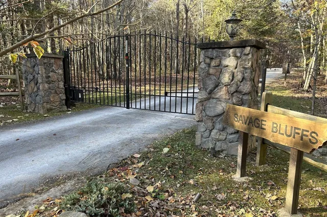 a view of a bench with wooden fence