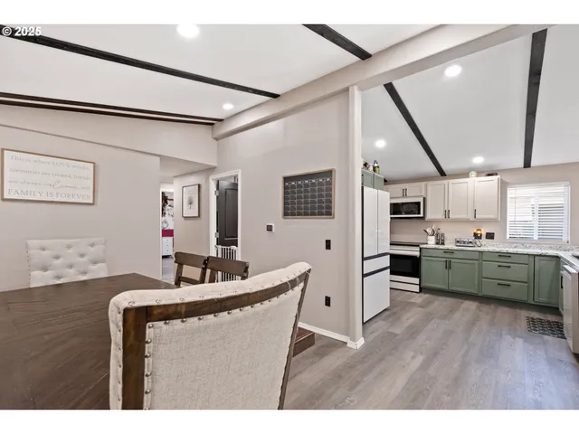 a kitchen with kitchen island granite countertop a sink cabinets and stainless steel appliances
