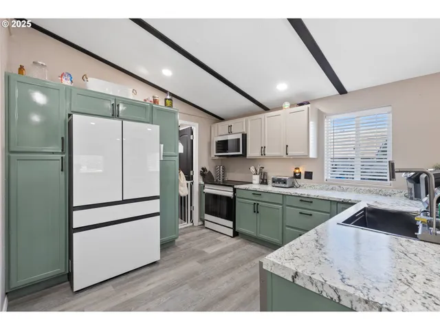 a kitchen with a refrigerator and a sink