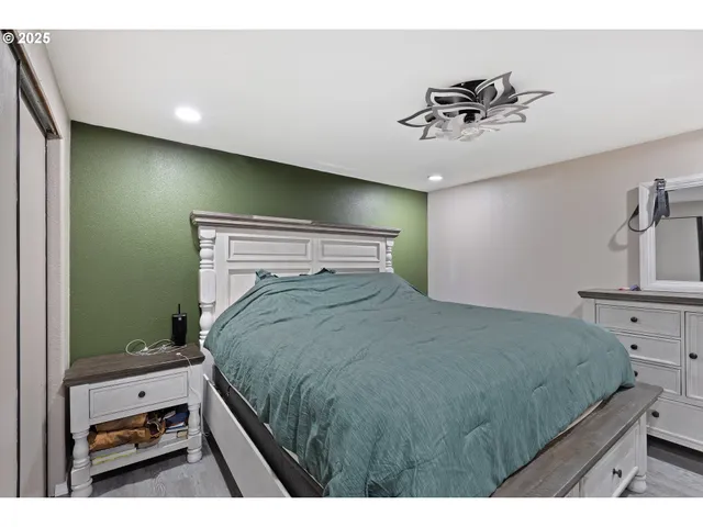 a bedroom with a bed and a chandelier