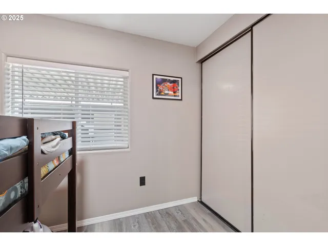 a view of a bedroom with bed and a window
