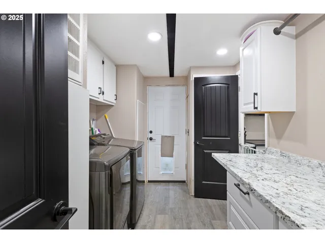 a kitchen with a sink refrigerator and cabinets