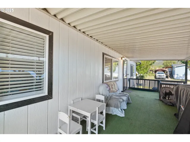 a balcony with furniture and a potted plant