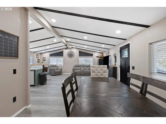 a view of a hallway with a livingroom with furniture