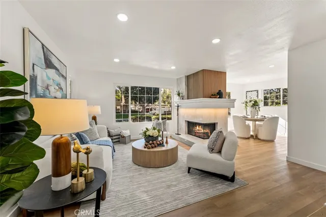 a living room with furniture a fireplace and a potted plant