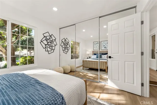 a bedroom with a large bed and a window