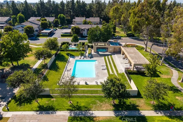 an aerial view of a house with a garden and swimming pool