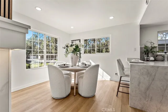 a dining room with furniture and wooden floor