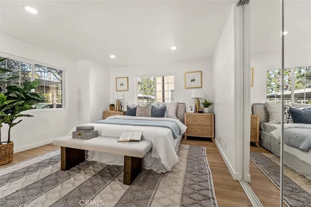 a bed room with a bed and a potted plant