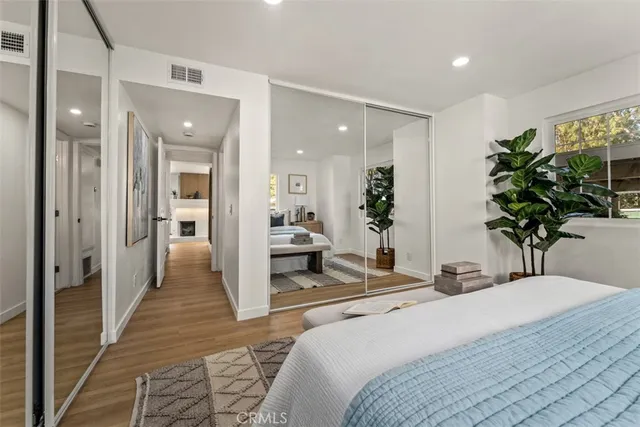 a bedroom with a bed and a potted plant