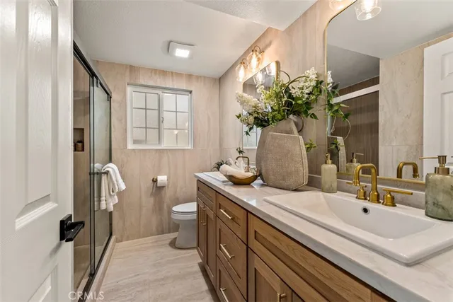 a bathroom with a double vanity sink and a mirror