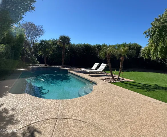 a view of a swimming pool with a yard
