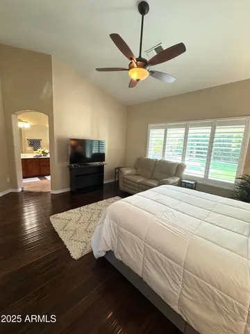 a bedroom with a bed and wooden floor