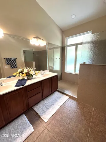 a bathroom with a tub sink and mirror
