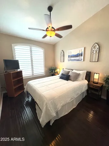 a bedroom with a bed and wooden floor