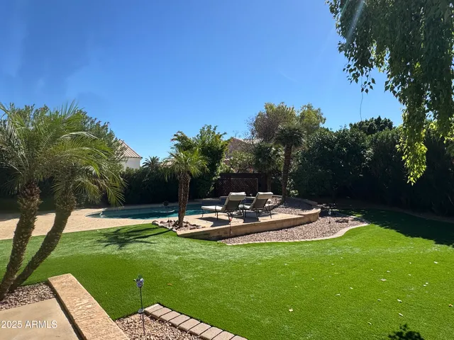 a view of a table and chairs in the garden