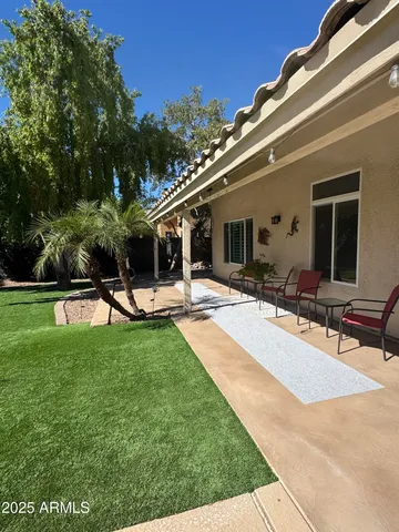 a swimming pool with outdoor seating and yard