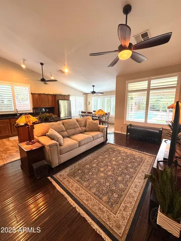a living room with furniture and a chandelier