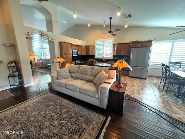 a living room with furniture and wooden floor