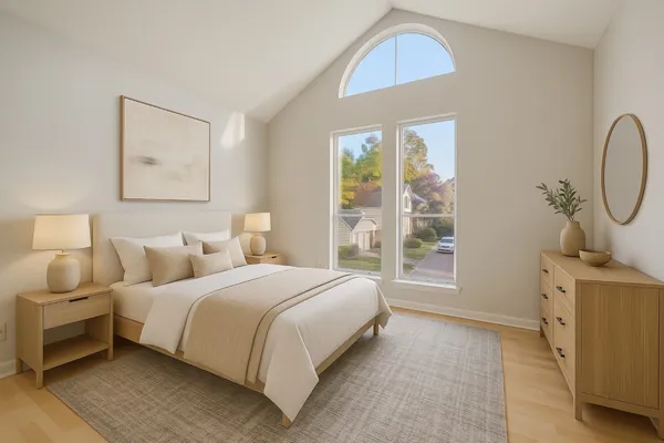 a bedroom with a bed a window and potted plant