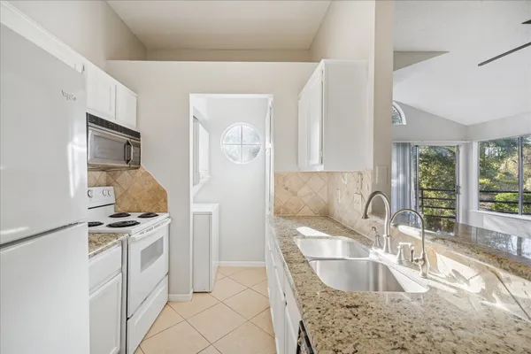 a kitchen with kitchen island stainless steel appliances a sink stove and refrigerator