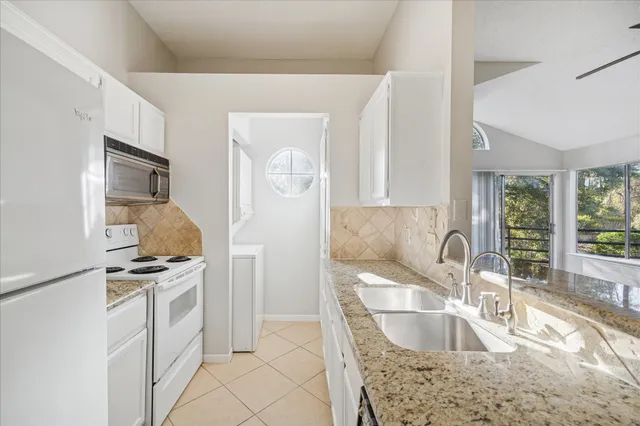 a kitchen with kitchen island stainless steel appliances a sink stove and refrigerator