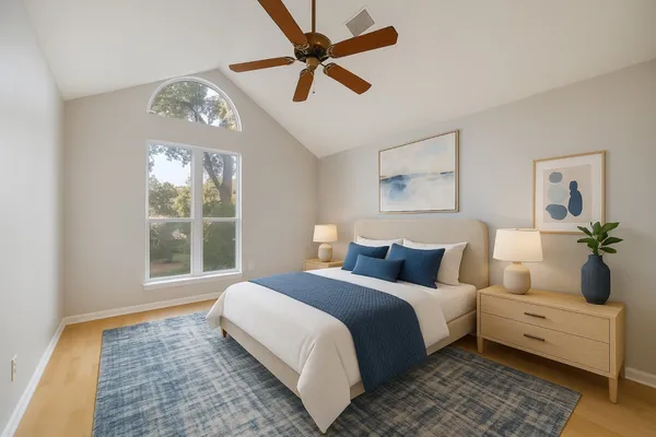 a bedroom with a large bed and a window