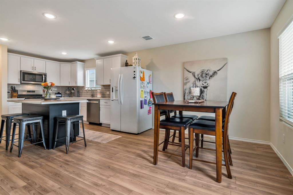 1228 Viscount Street Haslet, TX 76052 - Photo 12 of 28 a view of a dining room with furniture and wooden floor