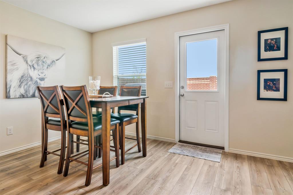 1228 Viscount Street Haslet, TX 76052 - Photo 13 of 28 a view of a dining room with furniture and wooden floor