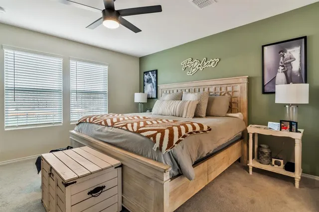 a bedroom with a bed and a flat tv screen