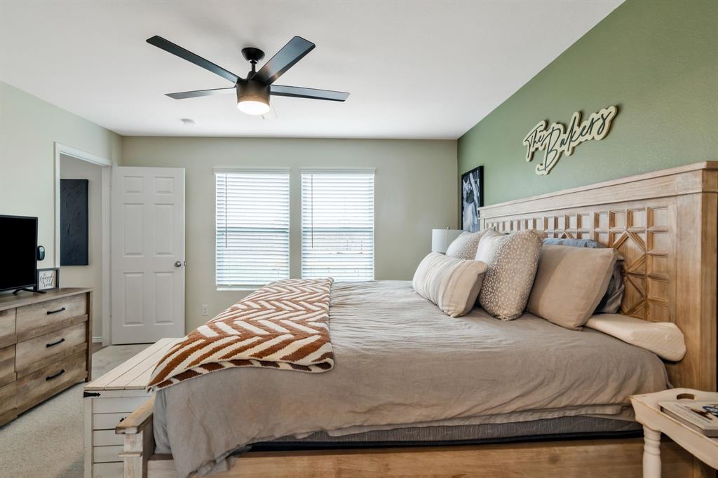 1228 Viscount Street Haslet, TX 76052 - Photo 16 of 28 a bedroom with a bed and a flat tv screen