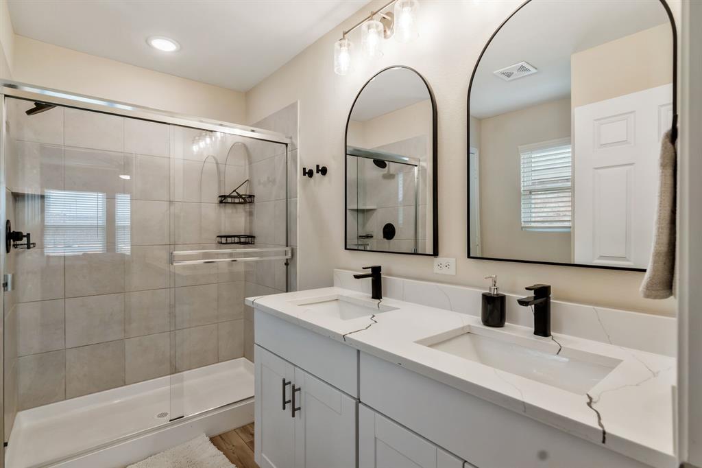 1228 Viscount Street Haslet, TX 76052 - Photo 17 of 28 a bathroom with a double vanity sink mirror and shower