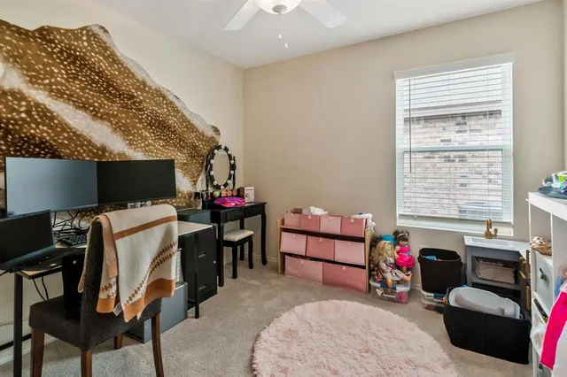 a bathroom with a granite countertop toilet sink and mirror