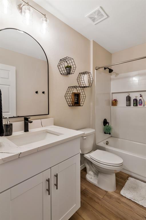 1228 Viscount Street Haslet, TX 76052 - Photo 21 of 28 a bathroom with a granite countertop toilet sink and mirror