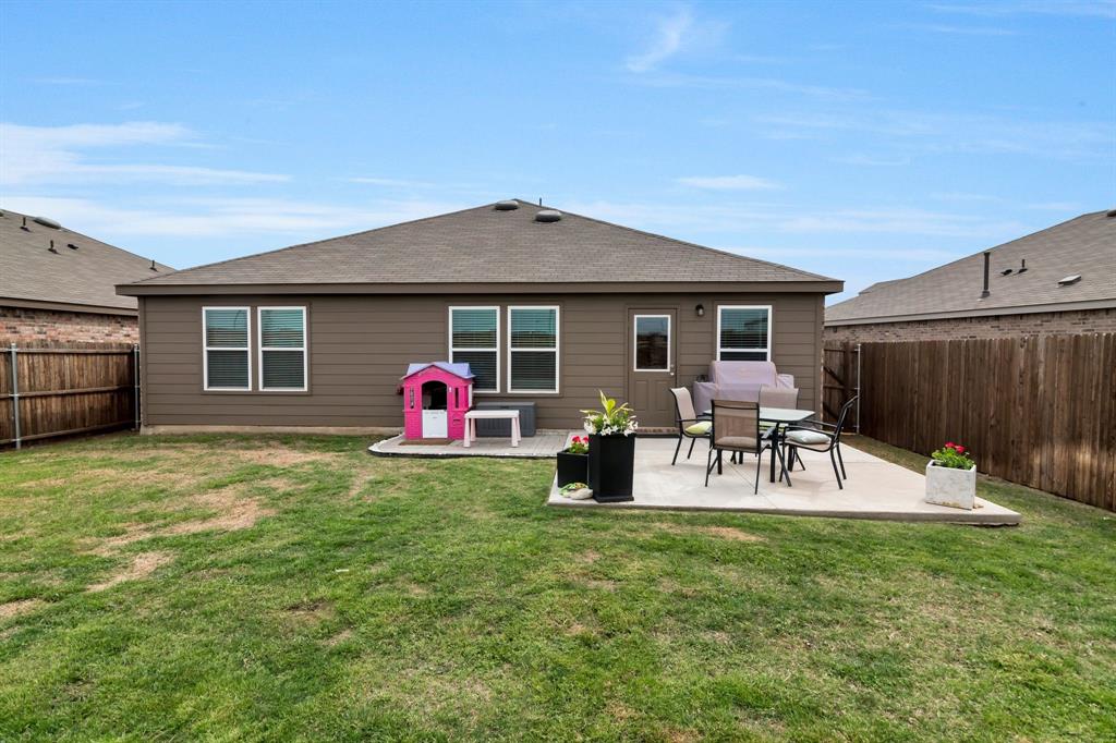 1228 Viscount Street Haslet, TX 76052 - Photo 26 of 28 a view of a house with a backyard and chairs