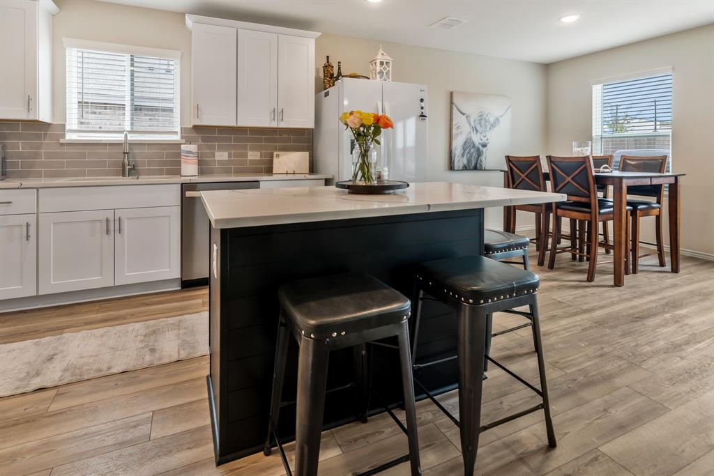 1228 Viscount Street Haslet, TX 76052 - Photo 6 of 28 a kitchen with a table chairs sink and cabinets