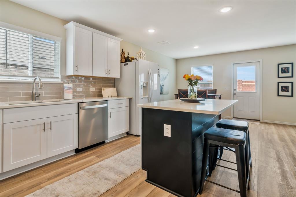 1228 Viscount Street Haslet, TX 76052 - Photo 7 of 28 a kitchen with a sink appliances and cabinets