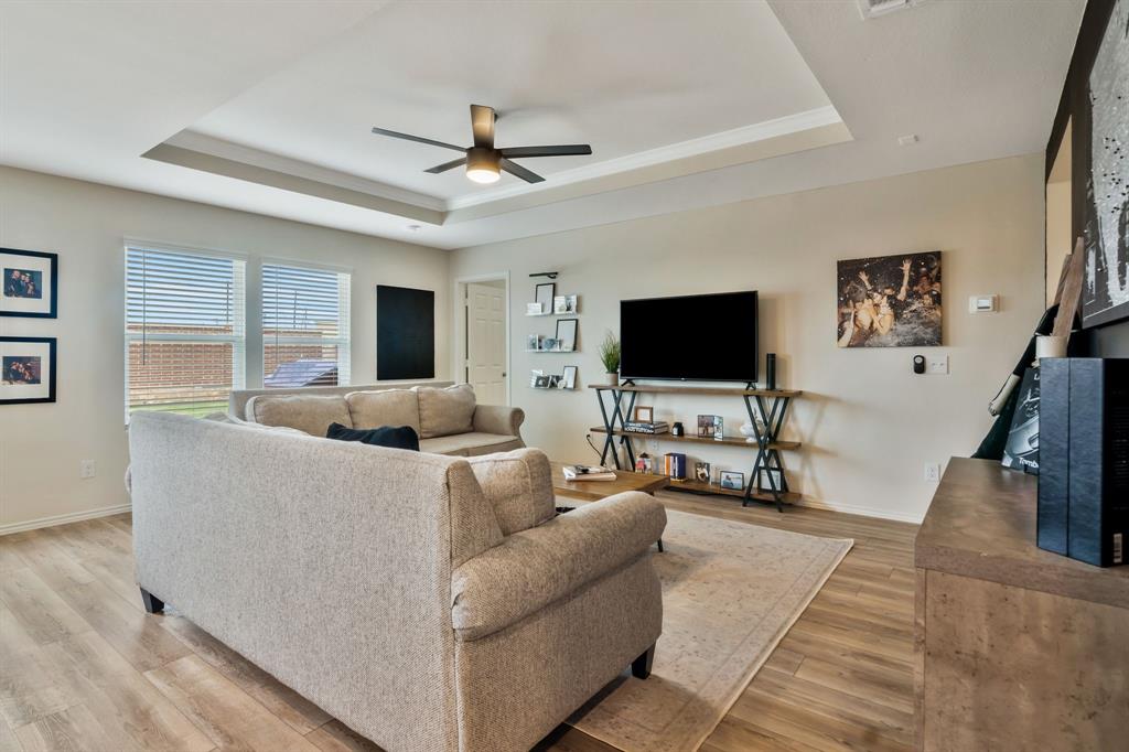1228 Viscount Street Haslet, TX 76052 - Photo 9 of 28 a living room with furniture and a flat screen tv