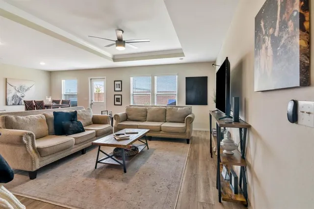 a living room with furniture and kitchen view