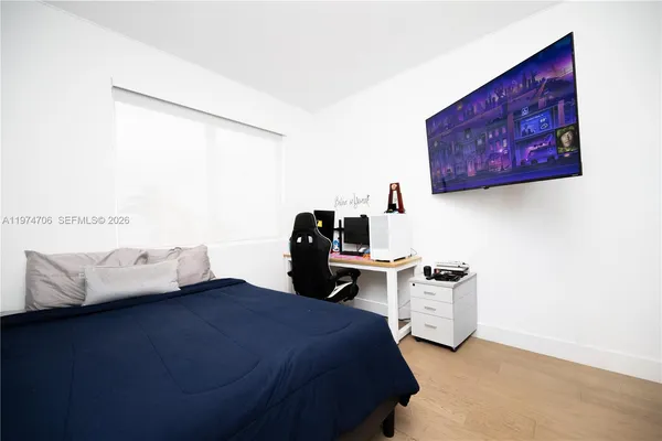 a large white bed in a white room