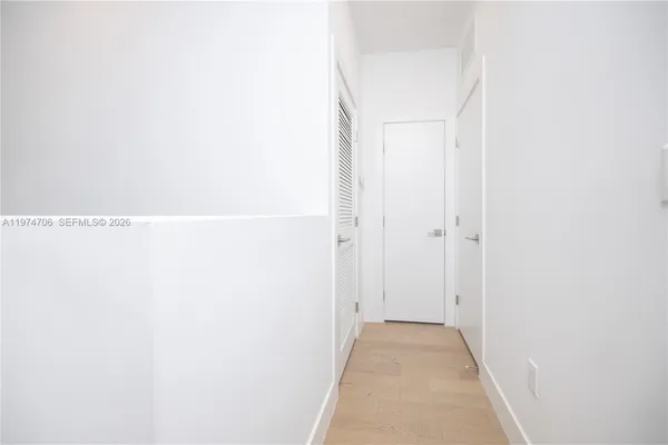 a white toilet sitting next to a shower