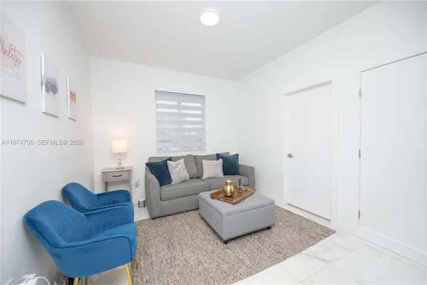 a living room with furniture flowerpot and a potted plant