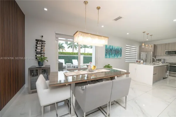 a kitchen with a sink a stove top oven and white cabinets