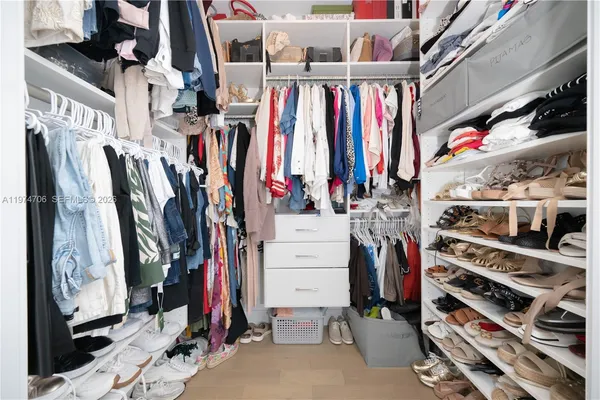 a bathroom with a sink tub double vanity and mirror