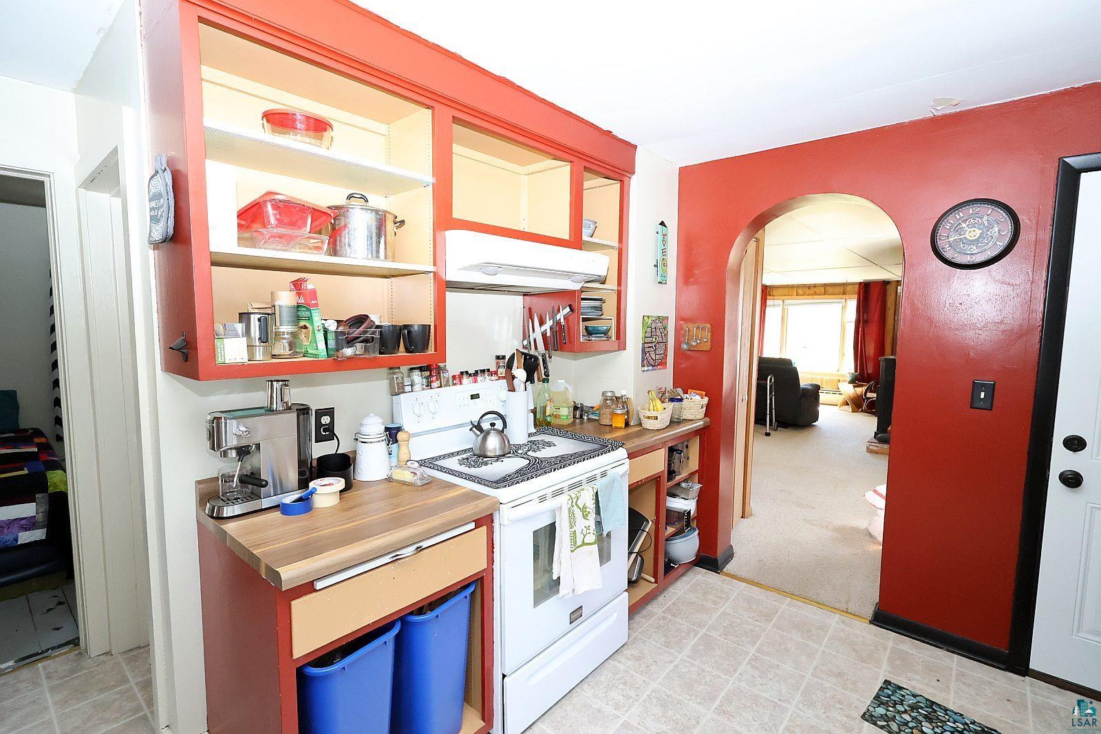 83185 Washington Avenue Port Wing, WI 54865 - Photo 11 of 26 Kitchen featuring red cabinetry, wood-finish countertops, and white appliances