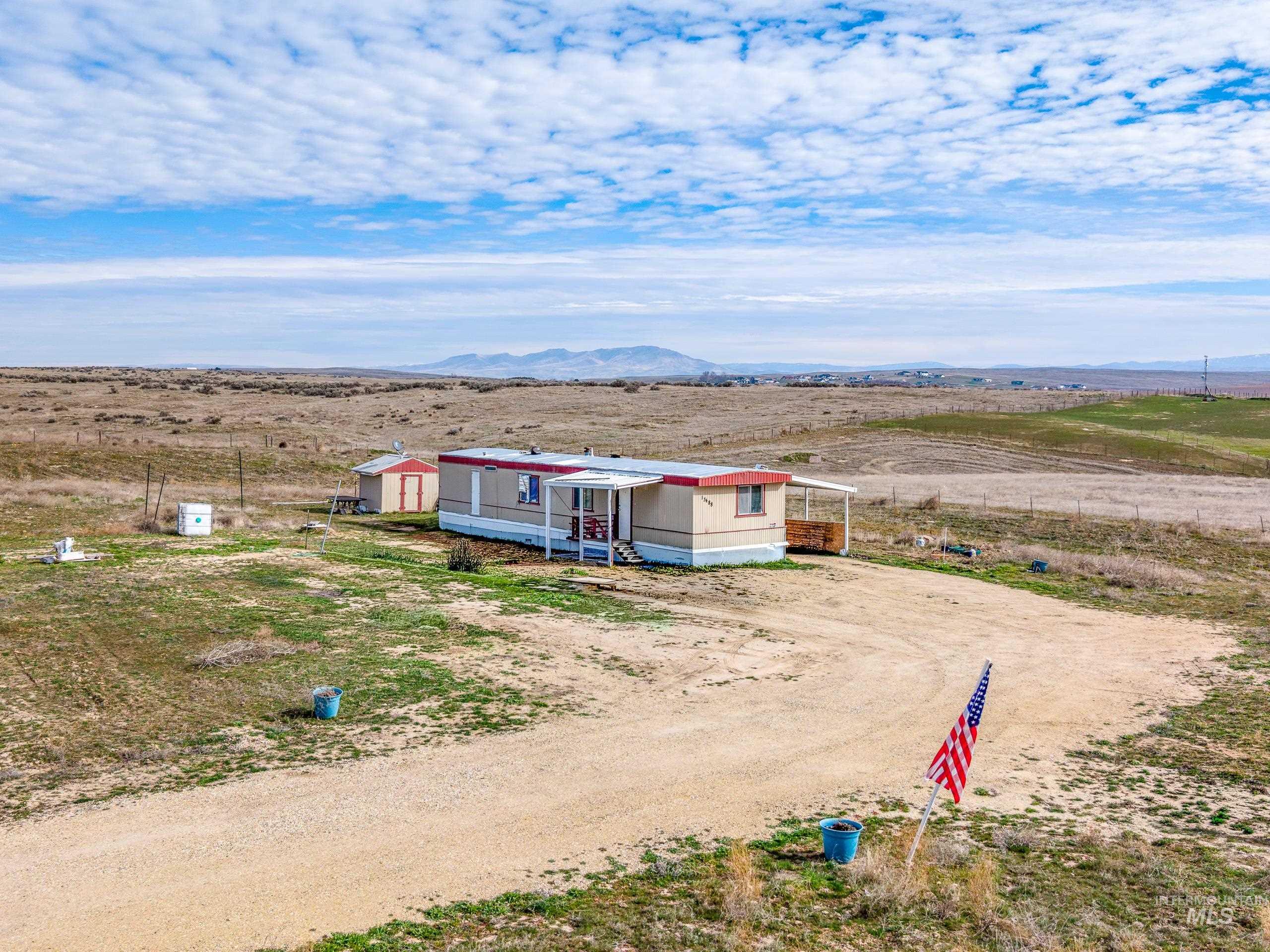 13488 Hollow Road Caldwell, ID 83607 - Photo 15 of 15 View of front of property featuring a view of countryside, a mountain view, and driveway