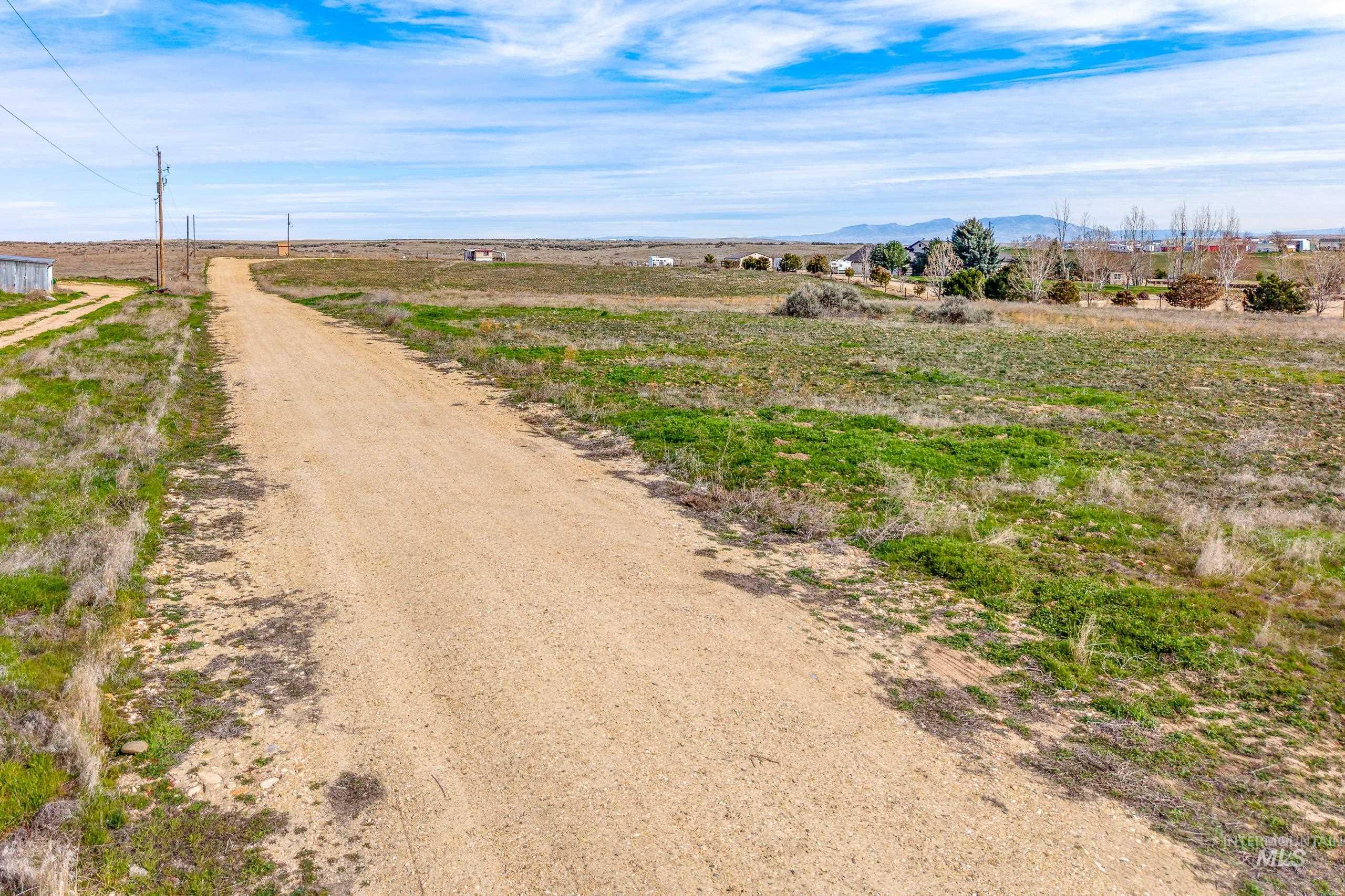 13488 Hollow Road Caldwell, ID 83607 - Photo 8 of 15 View of dirt / gravel road featuring a rural view and a mountain view