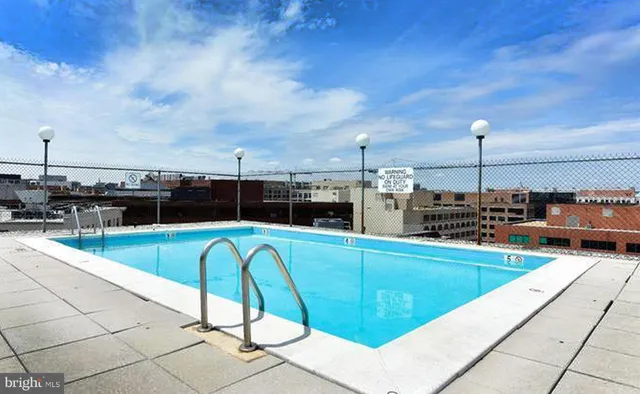 a view of a swimming pool with couches chairs