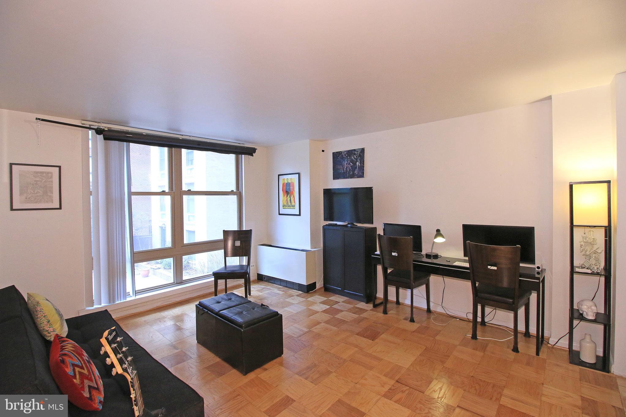 1260 21st Street Northwest, Unit 207 Washington, DC 20036 - Photo 3 of 16 a living room with furniture and a flat screen tv